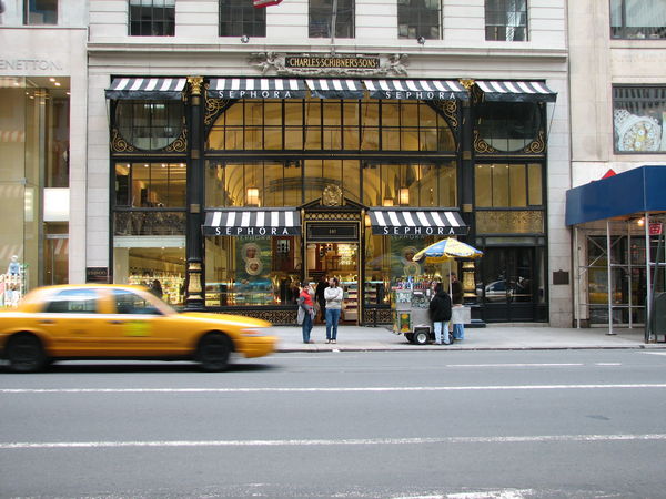 A yellow cab picks a client at Sephora shop